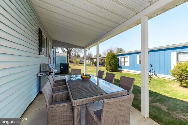 a view of an outdoor dining space with a table and chairs