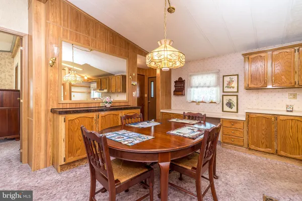 a view of a dining room with furniture and a chandelier