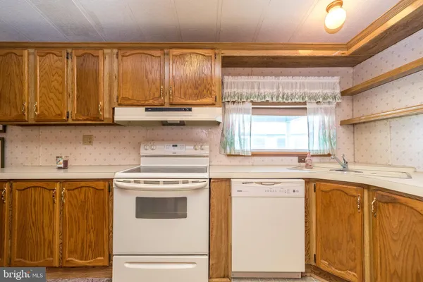 a kitchen with appliances cabinets and a sink