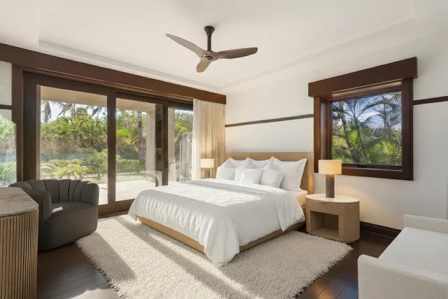 a bedroom with a large bed and a large window