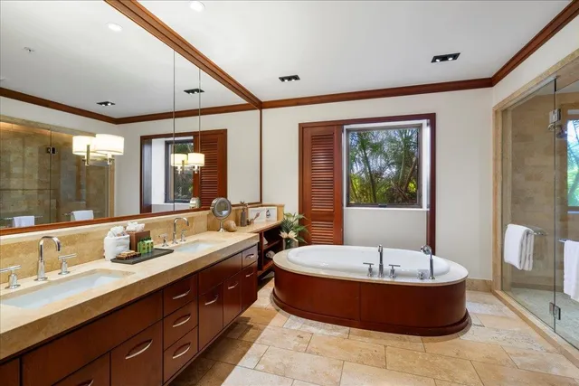 a spacious bathroom with a tub sink a mirror and a bathtub