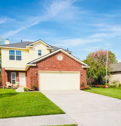 a front view of a house with a yard and garage