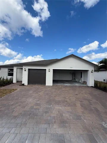 a view of a house with a yard and garage
