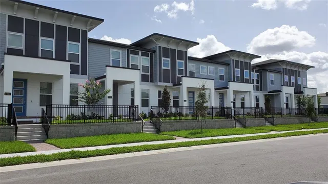 a view of a brick house next to a yard