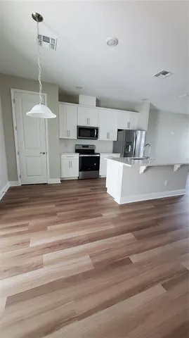 a kitchen with stainless steel appliances a refrigerator stove and microwave