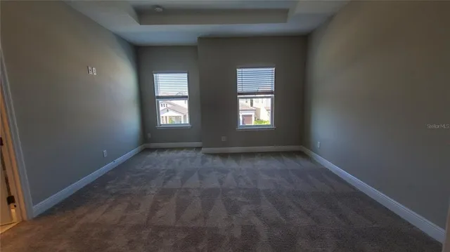 a view of an empty room with closet area