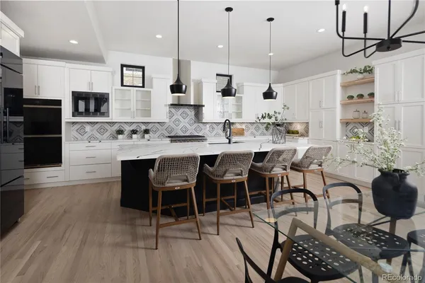 a large kitchen with a table and chairs