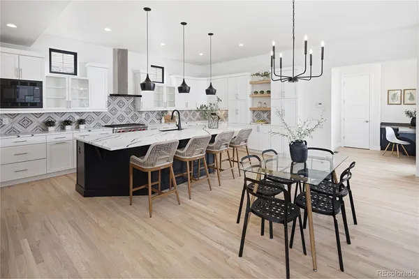 a large kitchen with a table and chairs
