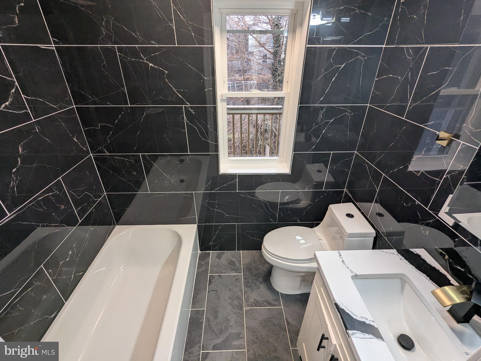 504 North Schroeder Street Baltimore, MD 21223 - Photo 13 of 32 a bathroom with a sink toilet and shower