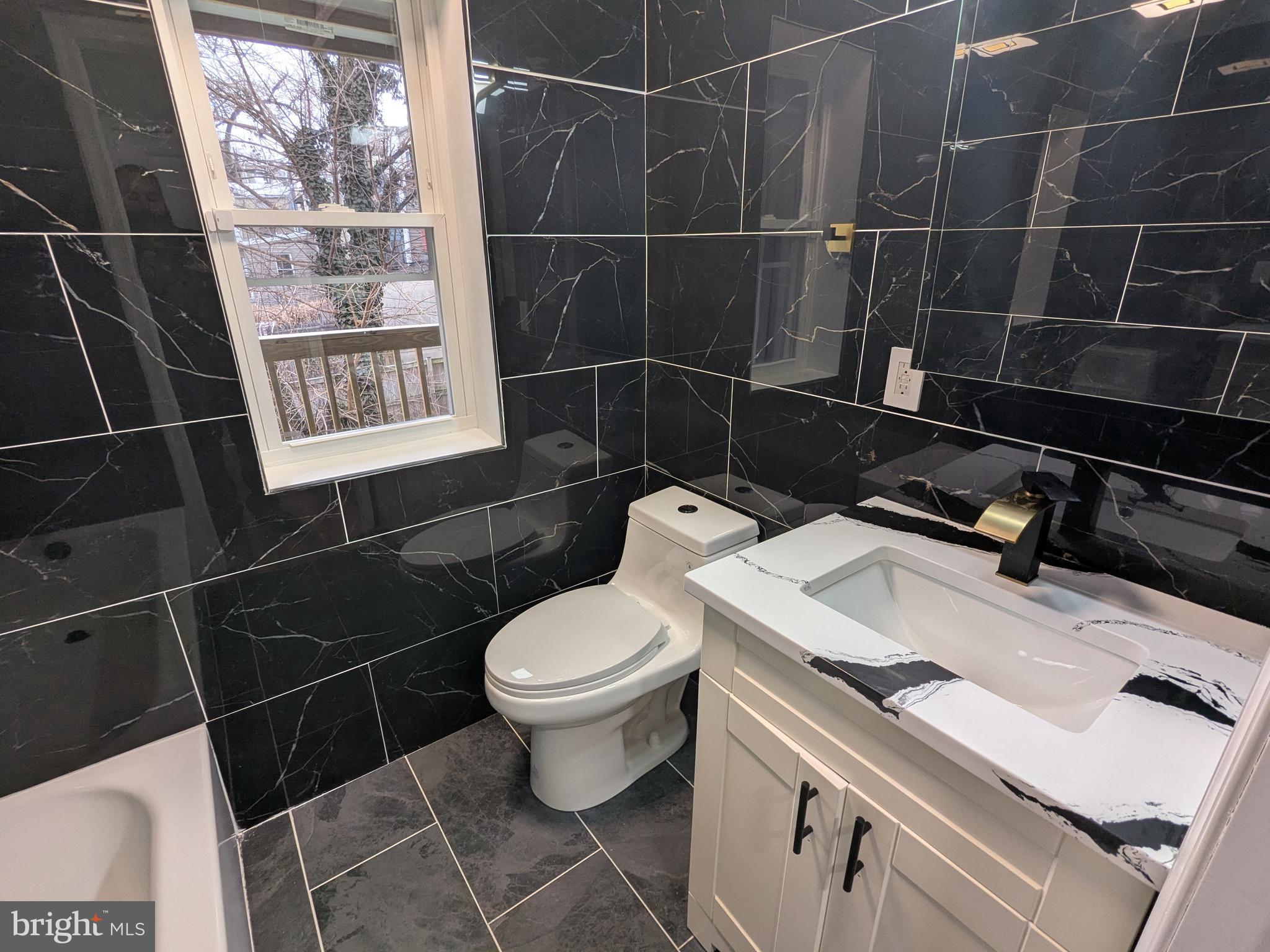 504 North Schroeder Street Baltimore, MD 21223 - Photo 14 of 32 a bathroom with a sink toilet and shower