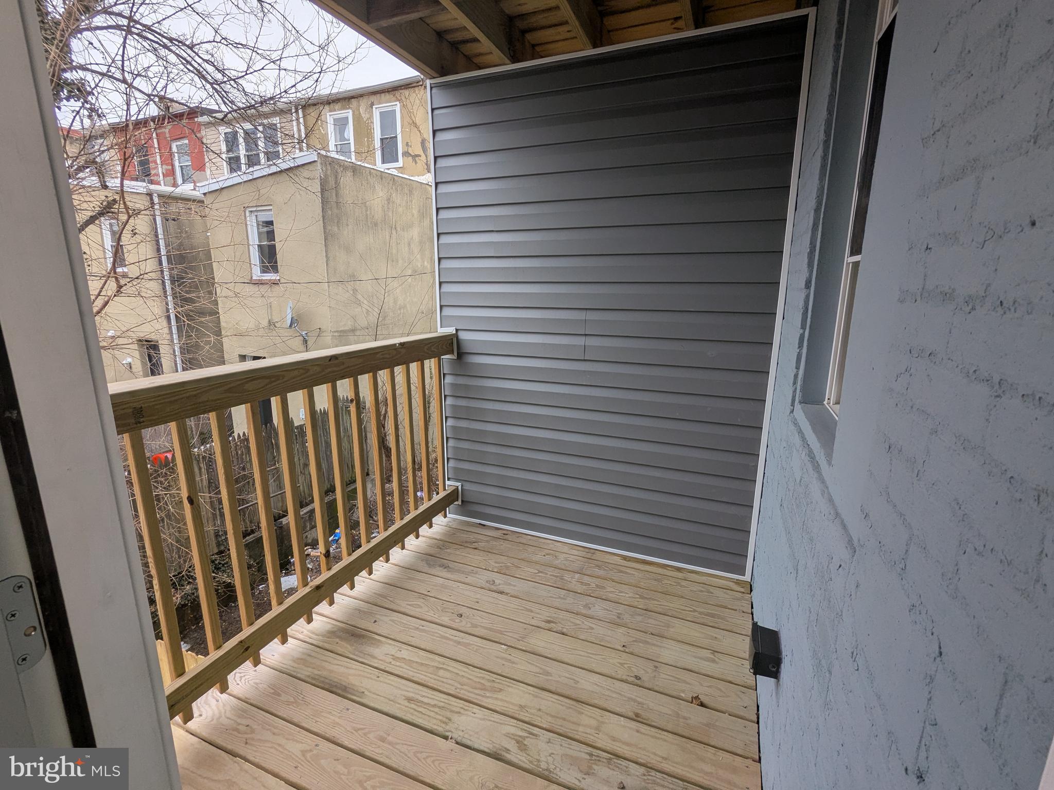 504 North Schroeder Street Baltimore, MD 21223 - Photo 15 of 32 a view of a balcony with wooden floor