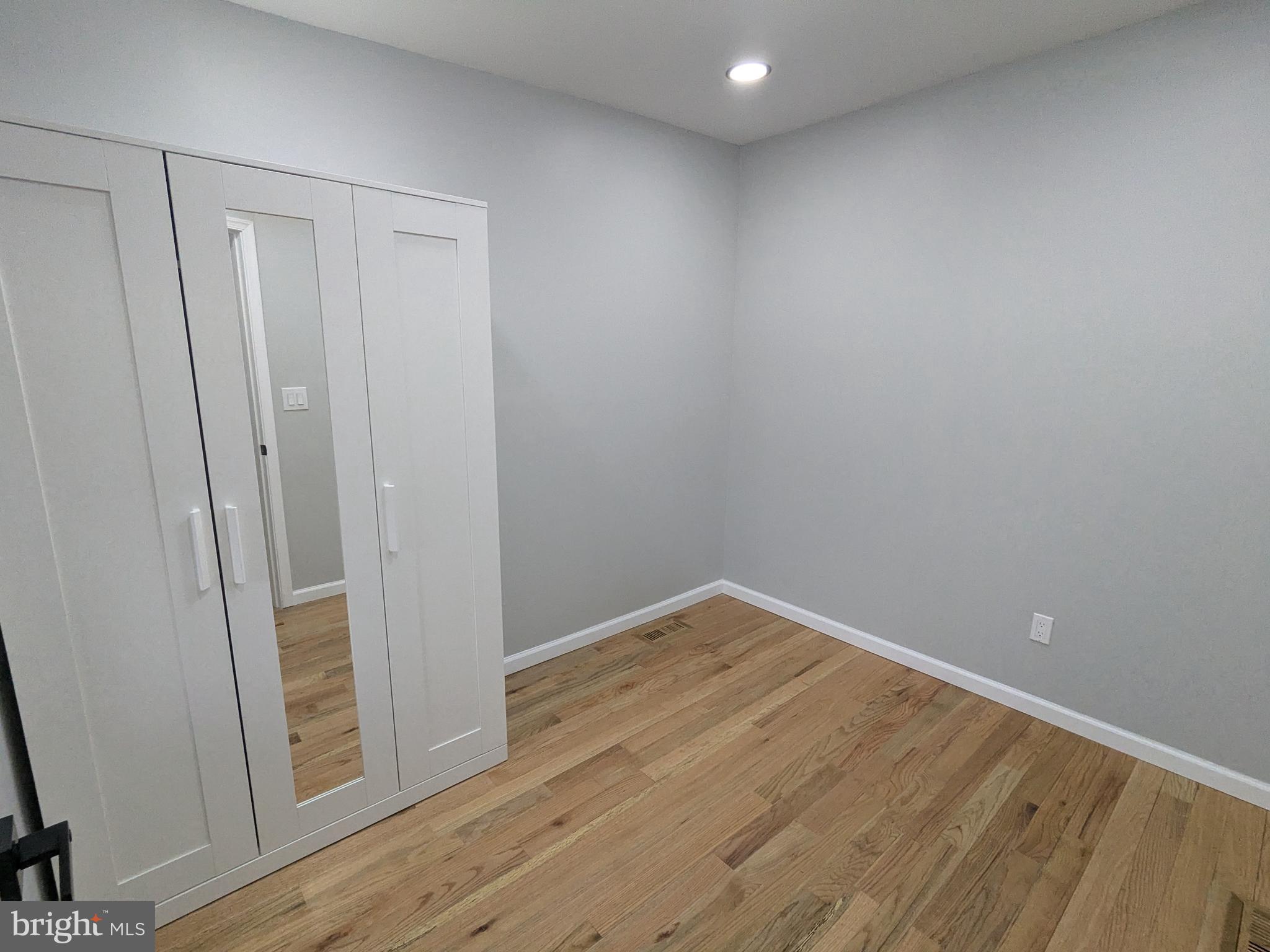 504 North Schroeder Street Baltimore, MD 21223 - Photo 17 of 32 a view of empty room with wooden floor