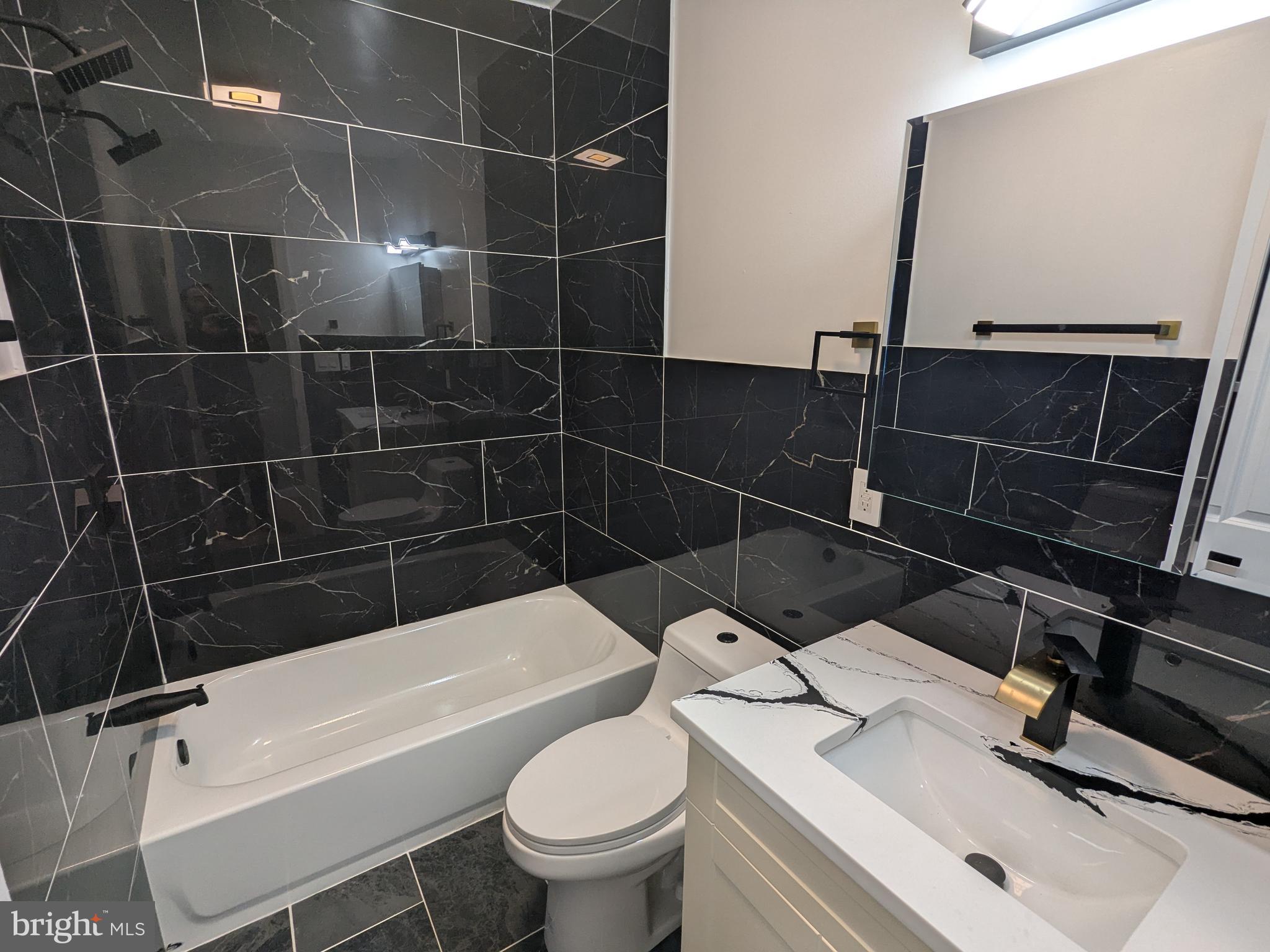 504 North Schroeder Street Baltimore, MD 21223 - Photo 19 of 32 a bathroom with a sink toilet and shower