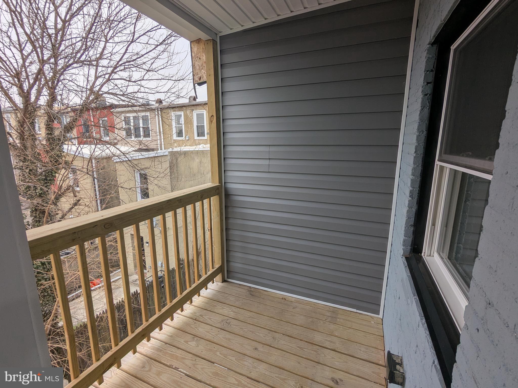 504 North Schroeder Street Baltimore, MD 21223 - Photo 22 of 32 a view of a balcony with wooden floor and fence
