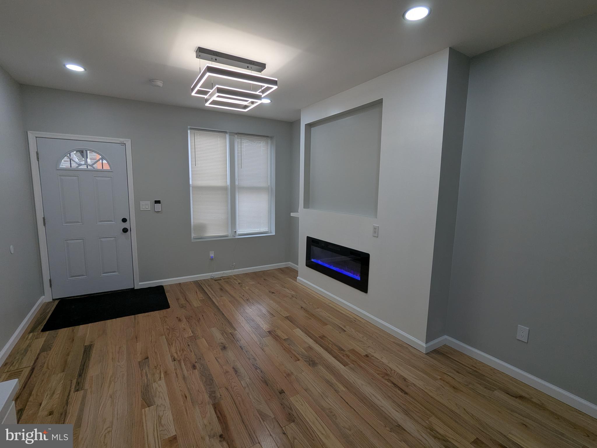 504 North Schroeder Street Baltimore, MD 21223 - Photo 5 of 32 a view of wooden floor and windows in a room