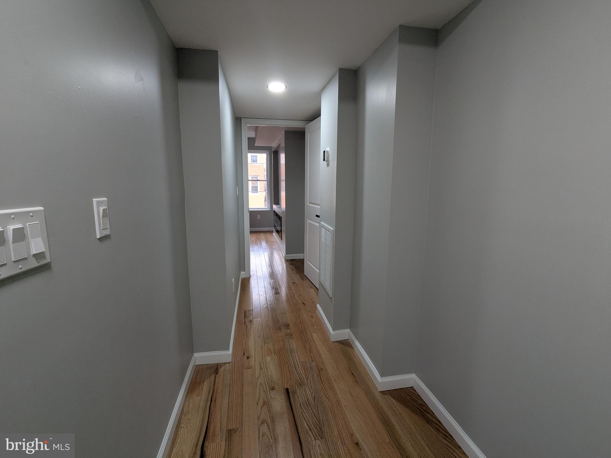504 North Schroeder Street Baltimore, MD 21223 - Photo 9 of 32 a view of a hallway with wooden floor