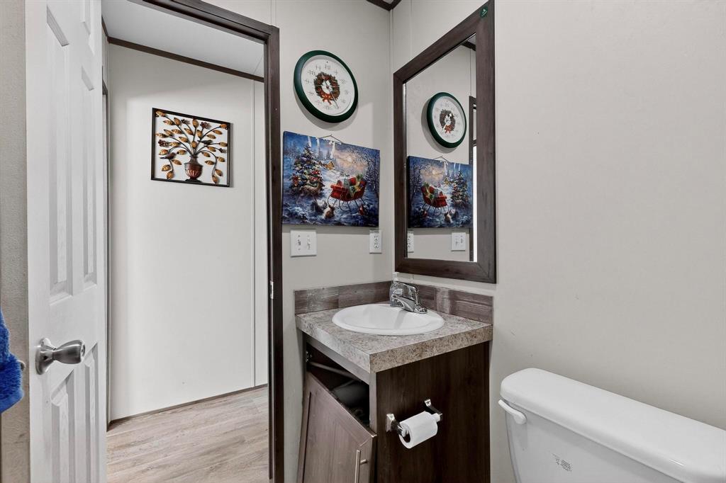 8450 North Farm To Market 148 Terrell, TX 75160 - Photo 16 of 38 Half bath with vanity and light wood-style floors
