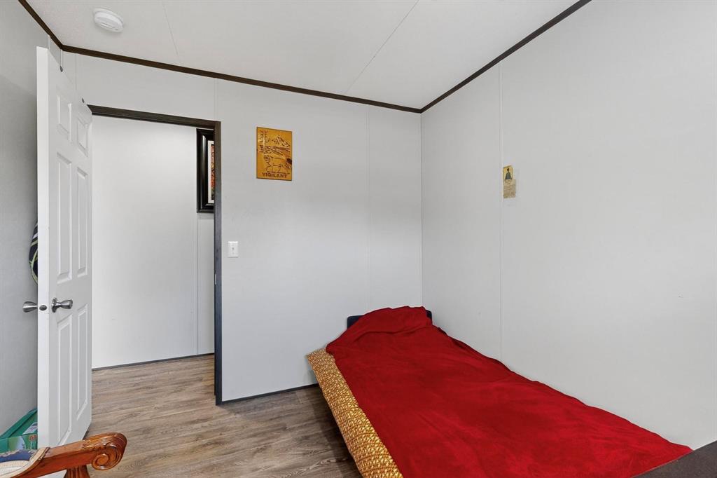 8450 North Farm To Market 148 Terrell, TX 75160 - Photo 25 of 38 Bedroom featuring wood finished floors and ornamental molding