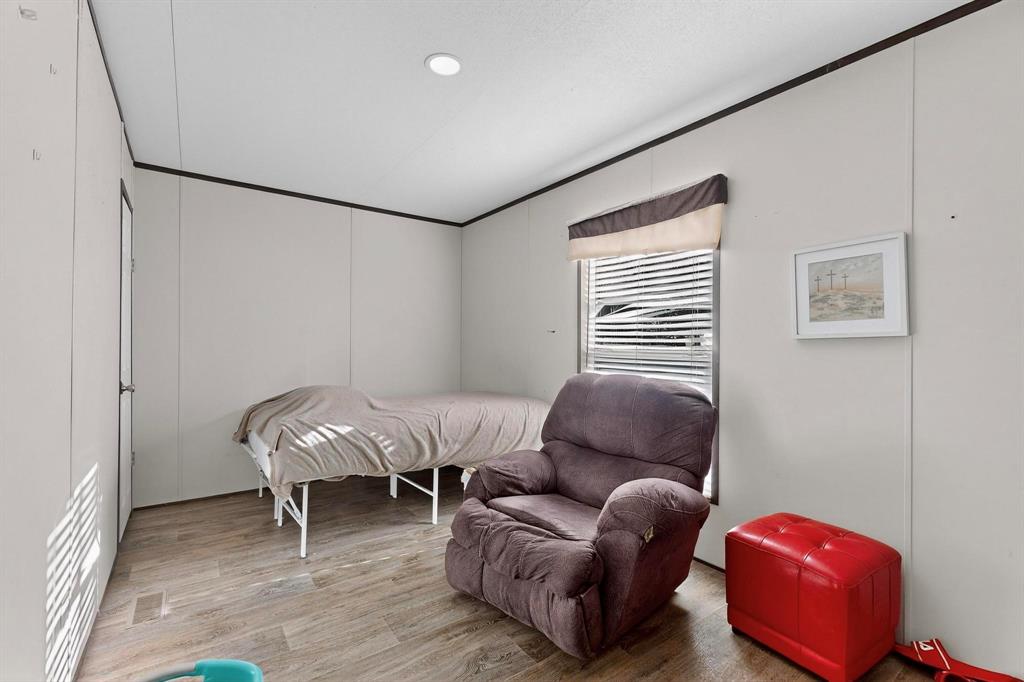 8450 North Farm To Market 148 Terrell, TX 75160 - Photo 26 of 38 Bedroom with wood finished floors, crown molding, and vaulted ceiling