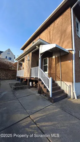 a view of a house with wooden fence