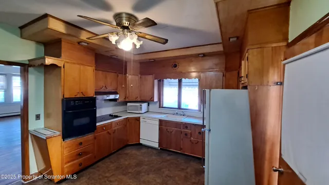 a kitchen with stainless steel appliances a sink and a refrigerator