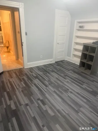 a view of a room with wooden floor and closet