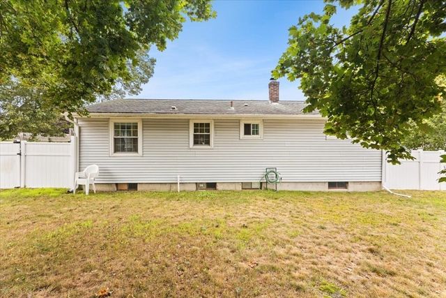 a white house that has a large pool in front of it