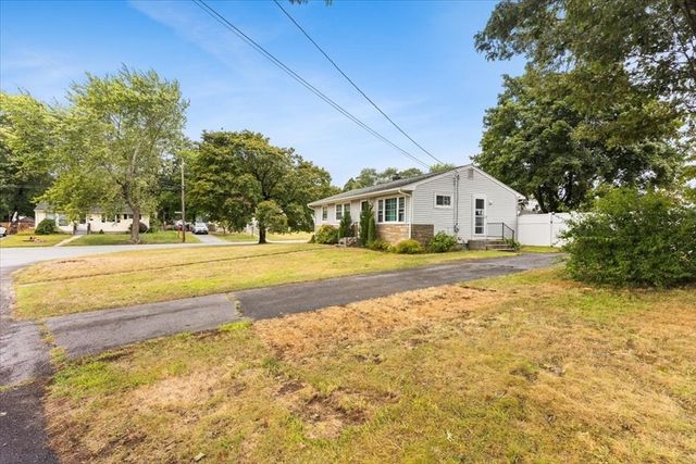 a house view with swimming pool in front of it
