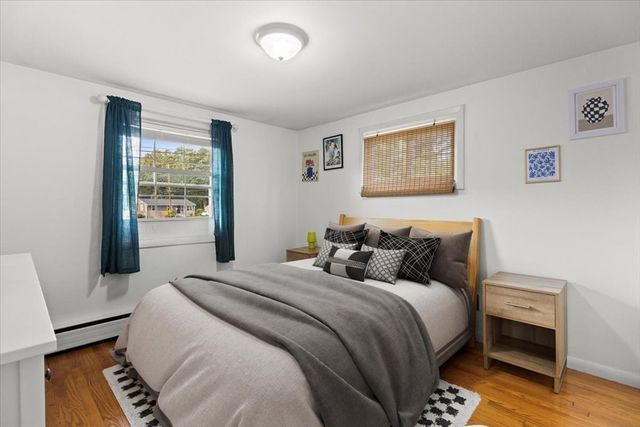 a bedroom with bed and wooden floor