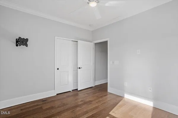 a view of an empty room with wooden floor