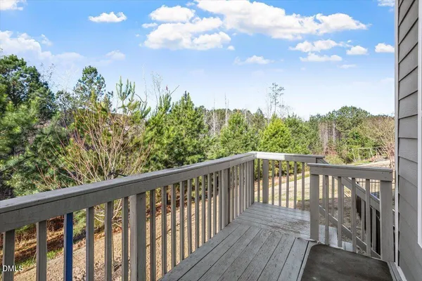 a balcony with wooden floor and fence