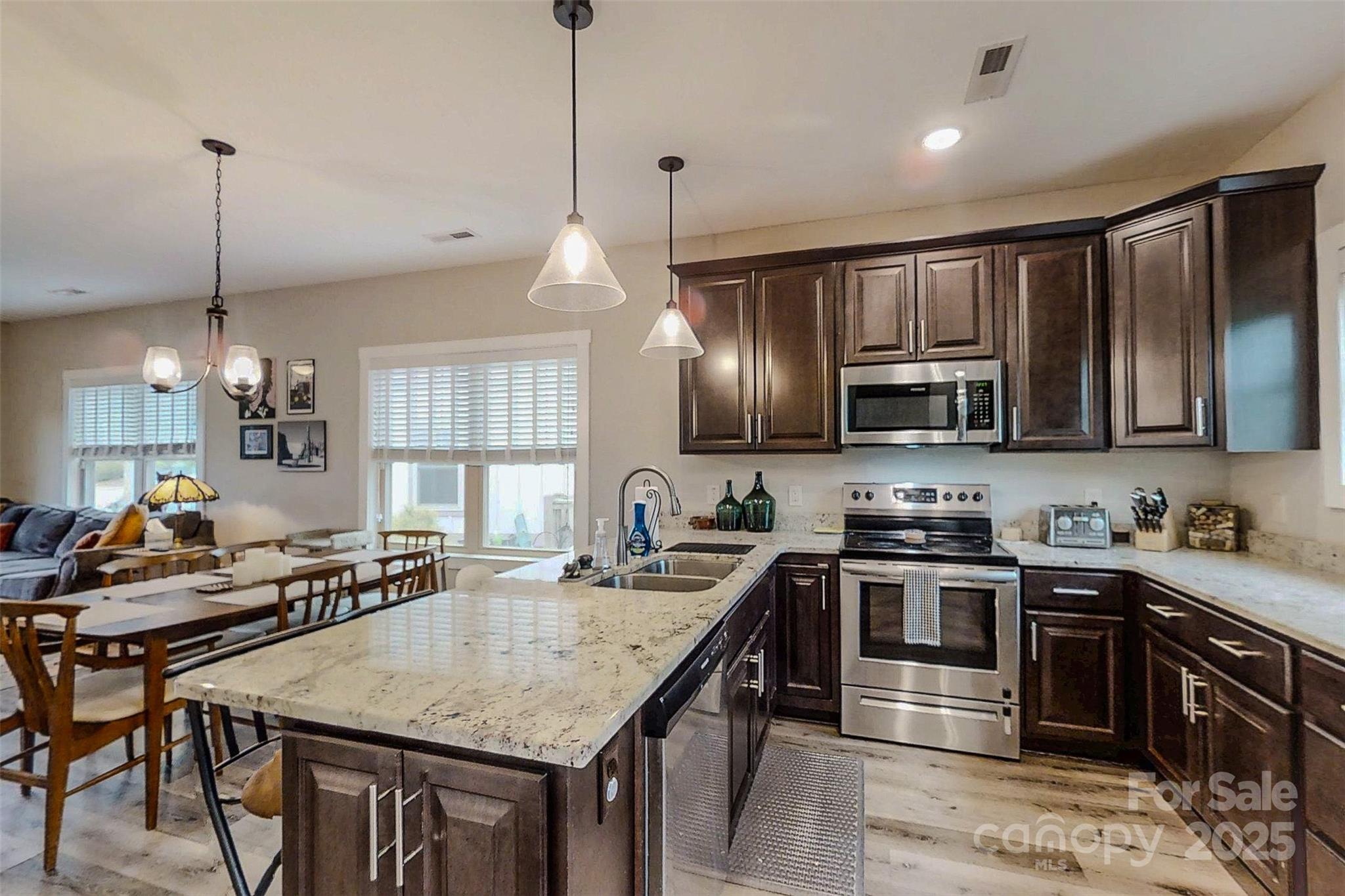104 Wheeler Road Weaverville, NC 28787 - Photo 13 of 38 a kitchen with granite countertop a sink a counter space appliances and cabinets