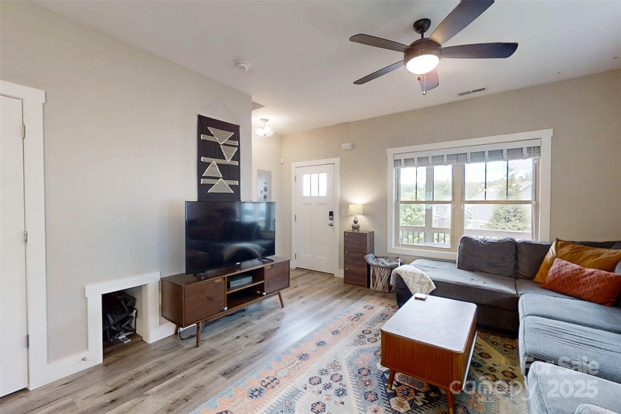 104 Wheeler Road Weaverville, NC 28787 - Photo 10 of 38 a living room with furniture and a flat screen tv