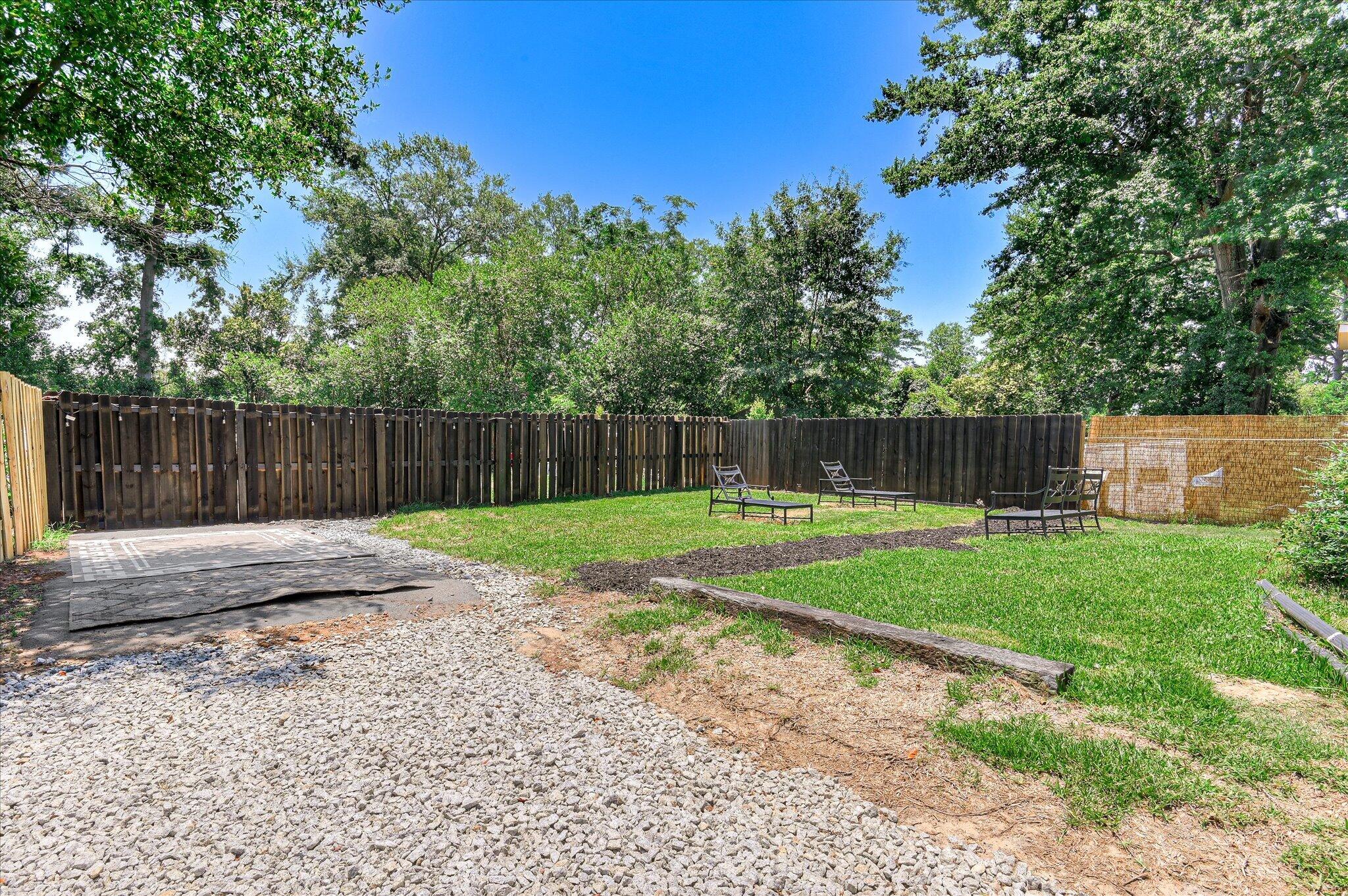 1121 Ridgecrest Avenue North Augusta, SC 29841 - Photo 38 of 42 a view of a backyard with large tree and wooden fence