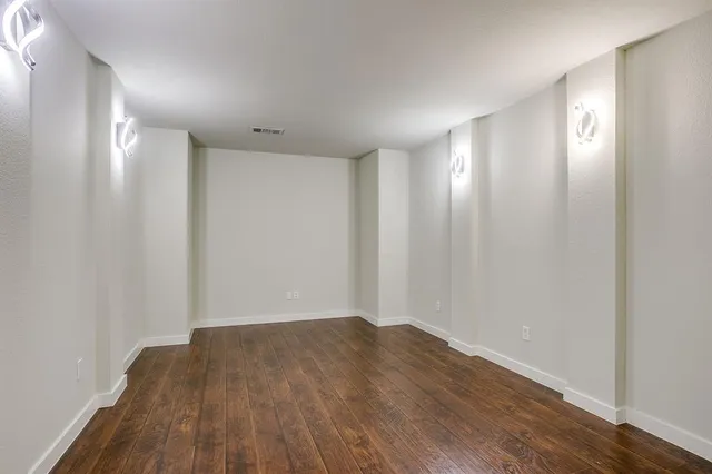 a view of a room with wooden floor