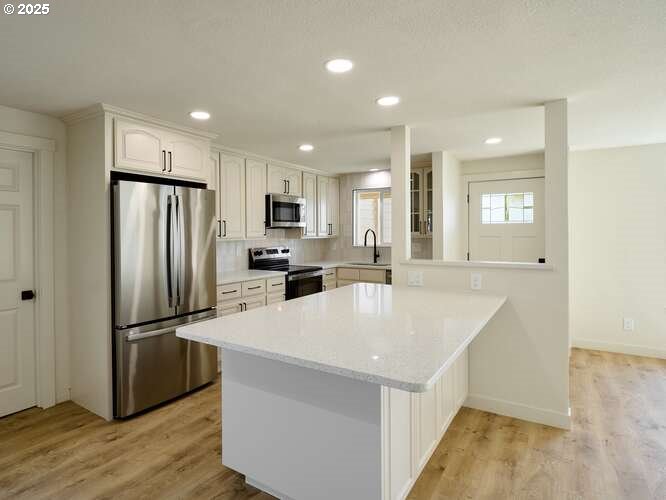 175 7th Street Gervais, OR 97026 - Photo 12 of 24 a kitchen with refrigerator cabinets and wooden floor