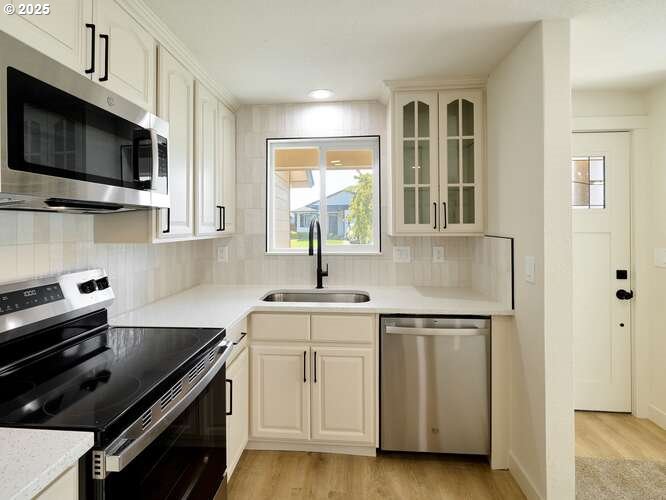 175 7th Street Gervais, OR 97026 - Photo 14 of 24 a kitchen with a sink stove and microwave