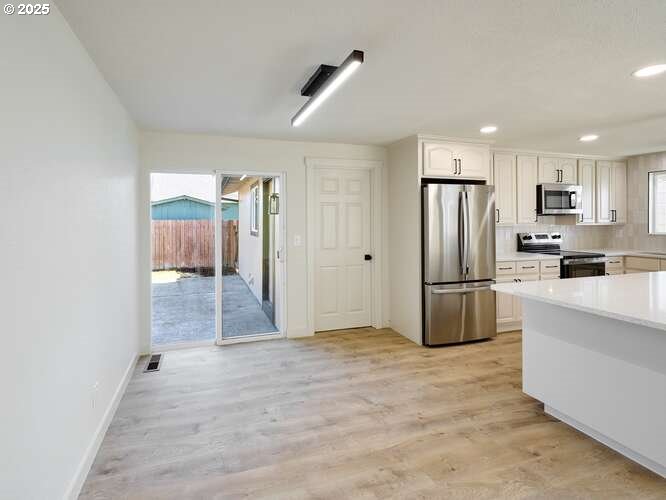 175 7th Street Gervais, OR 97026 - Photo 16 of 24 a view of a kitchen with refrigerator and white cabinets