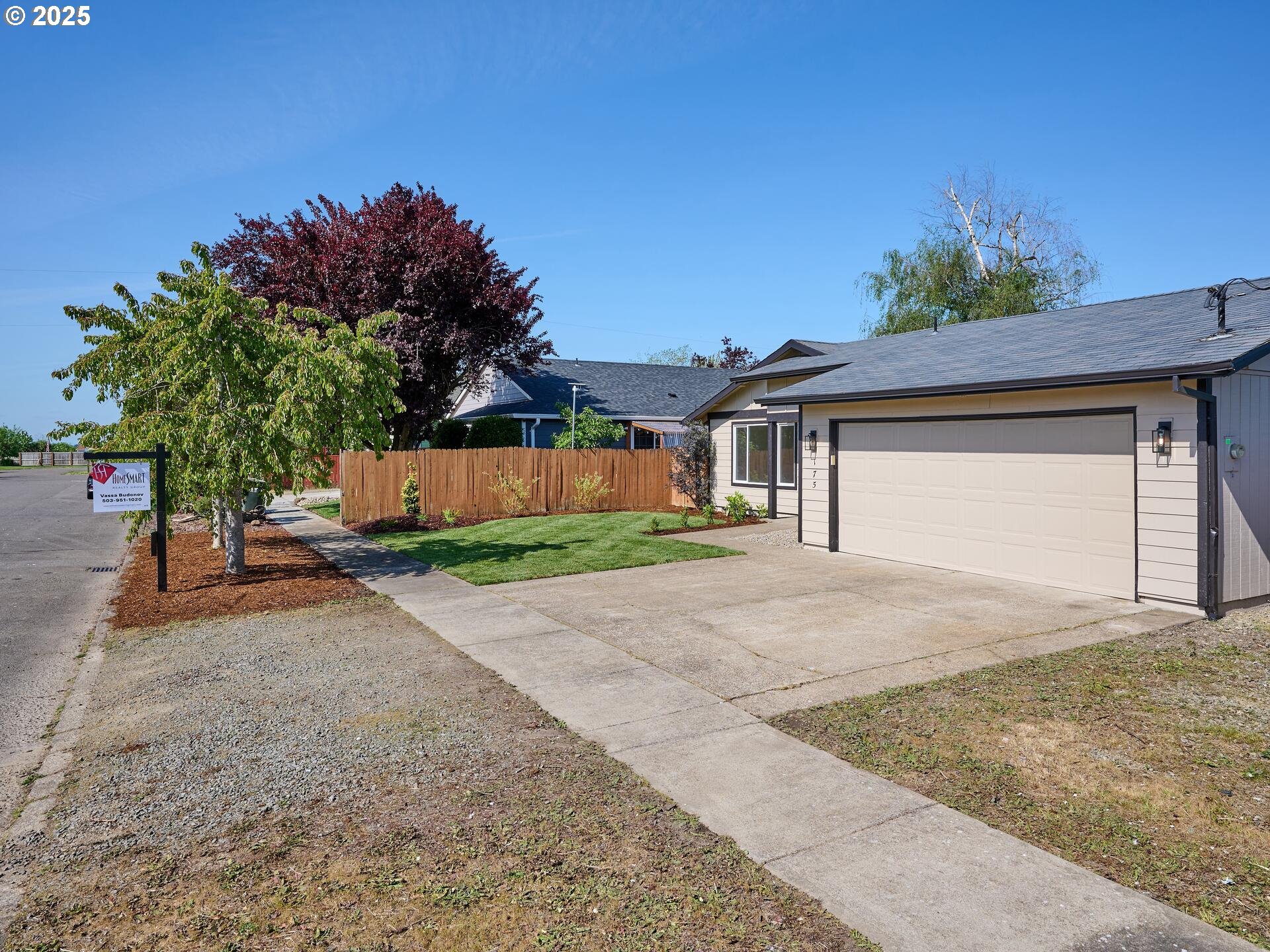 175 7th Street Gervais, OR 97026 - Photo 3 of 24 a front view of a house with a yard and a garage