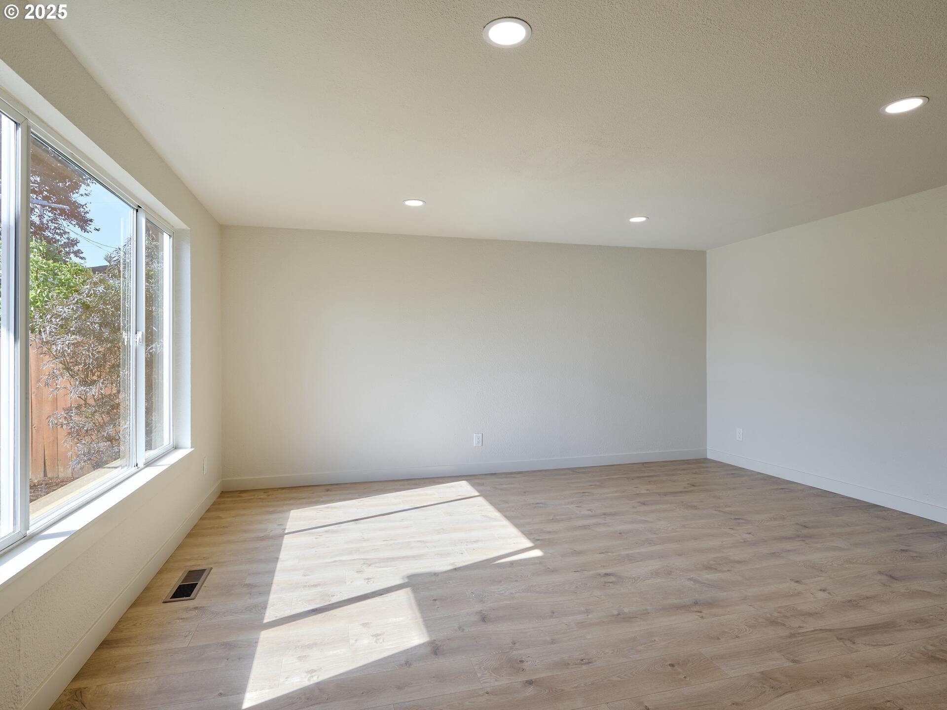 175 7th Street Gervais, OR 97026 - Photo 8 of 24 an empty room with wooden floor and windows