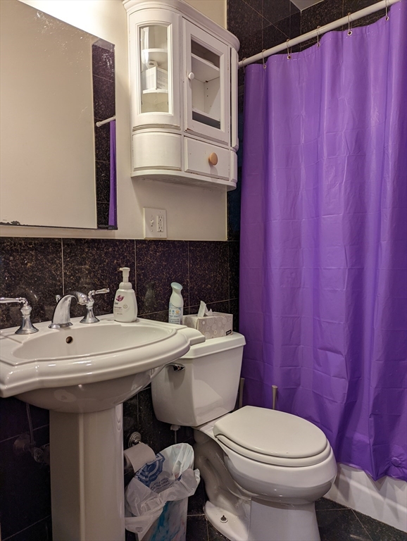 174 Winthrop Road, Unit 2 Brookline, MA 02445 - Photo 5 of 9 a bathroom with a sink a toilet and a mirror