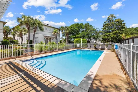 a view of a swimming pool with a lounge chairs