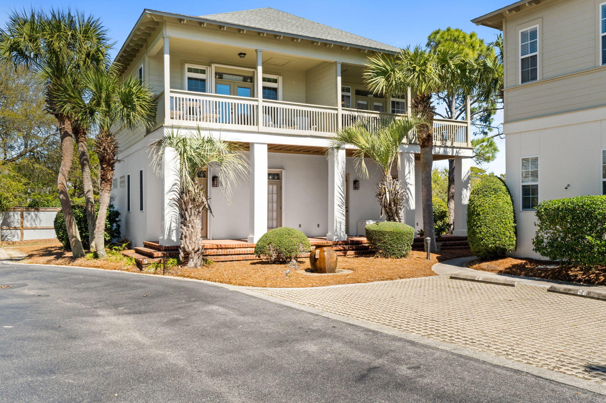 8329 East County Highway 30A, Unit 8 Seacrest, FL 32461 - Photo 18 of 21 a view of a building with potted plants and a large tree