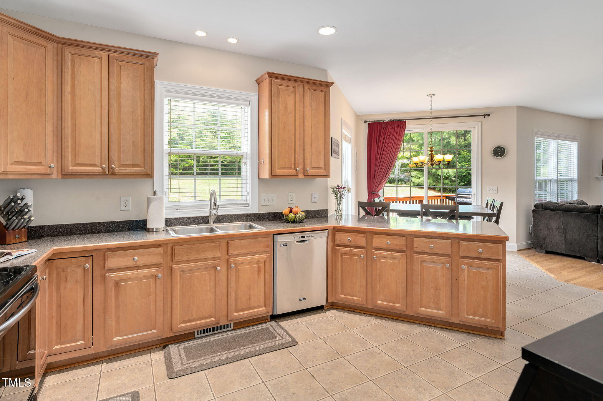 1106 Bellenden Drive Durham, NC 27713 - Photo 16 of 40 a kitchen with stainless steel appliances granite countertop a stove a sink and a refrigerator