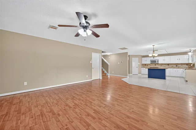 a view of a room with wooden floor and staircase