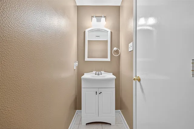 a bathroom with a sink mirror and toilet