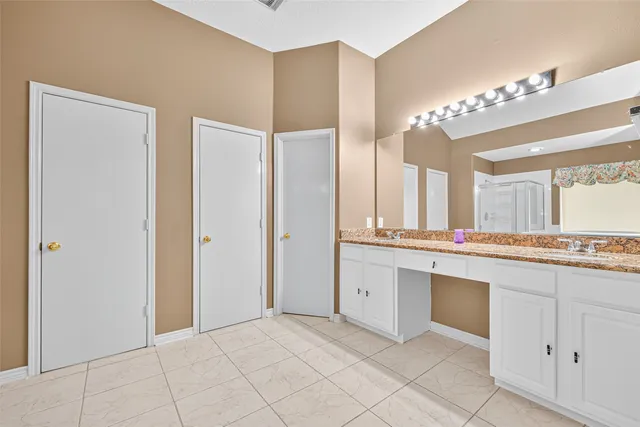 a large bathroom with a sink and a mirror