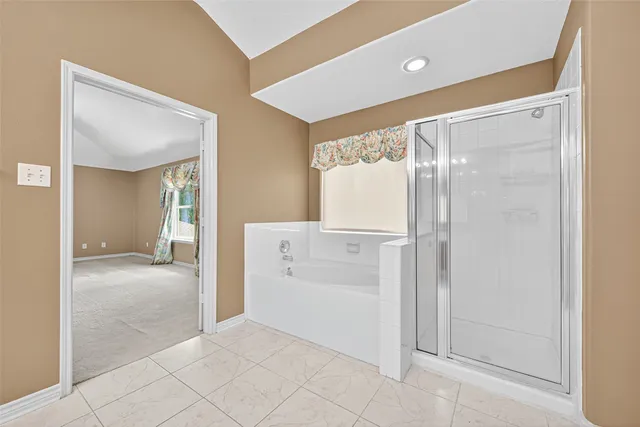 a view of a hallway with closet and bathroom