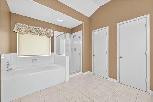 a bathroom with a bathtub and a shower