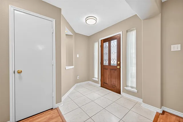a view of an empty room with wooden floor